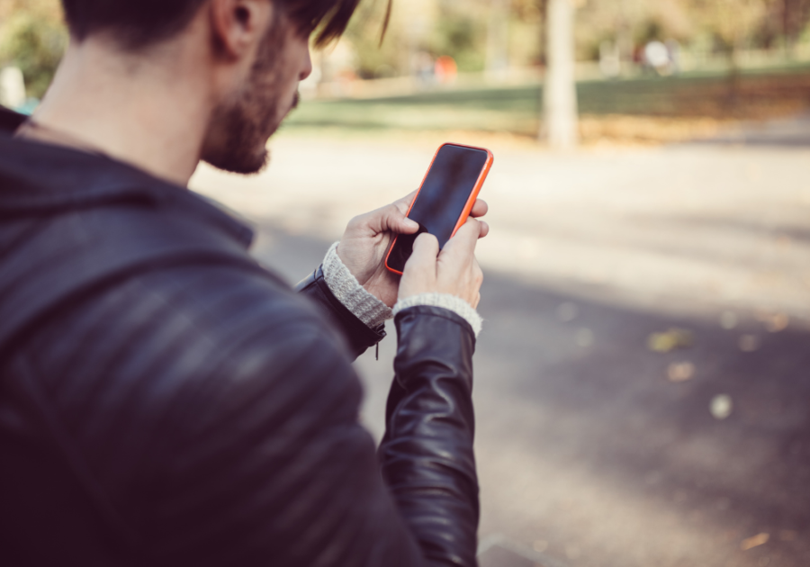 man using phone while on the streets is it ok to break up over text