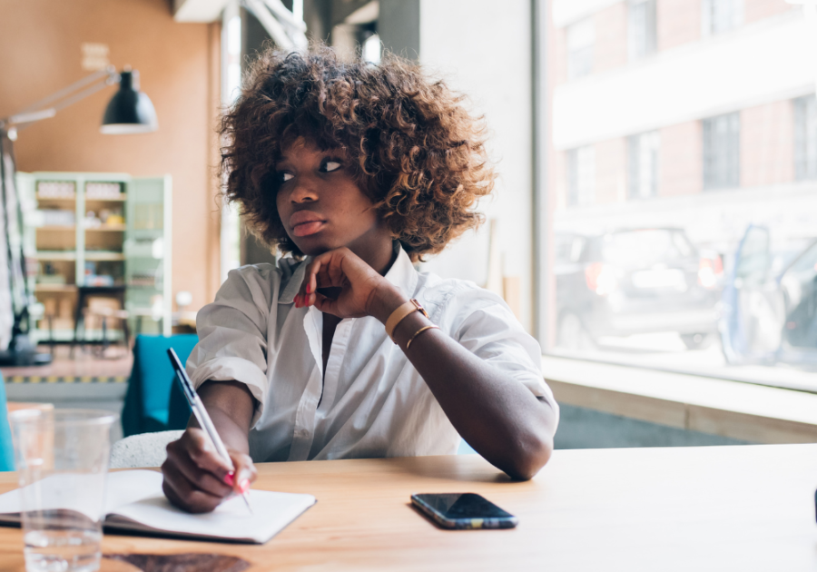 woman looking sideways while holding a pen letters for forgiveness