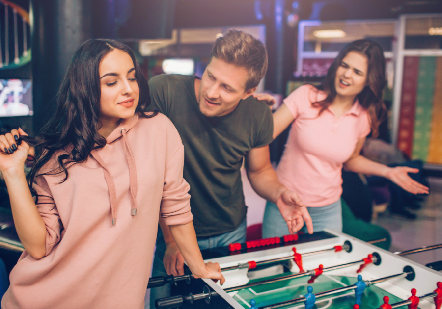 man talking to another woman while another is calling him signs of a player