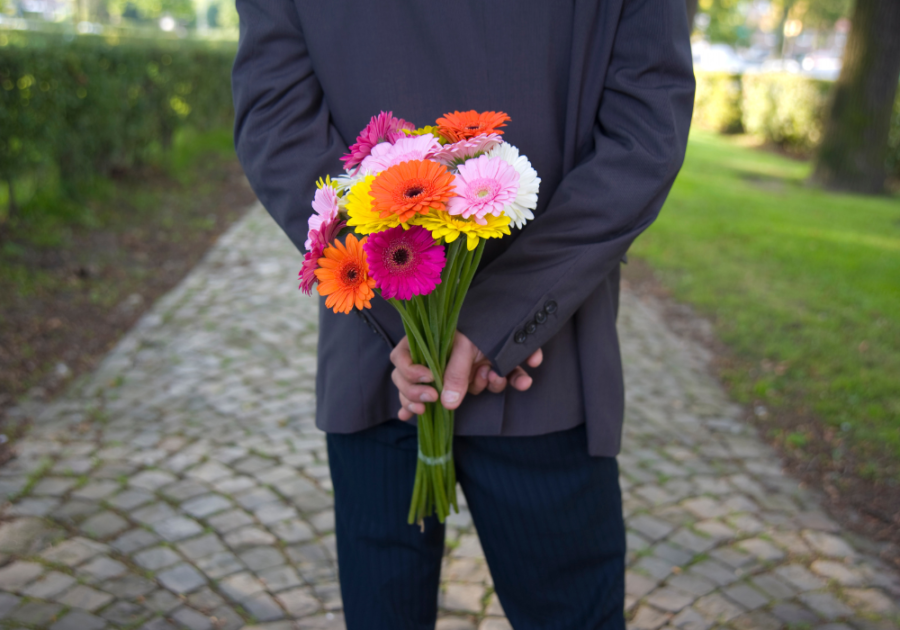 flowers being hidden in the back of a man effort in a relationship