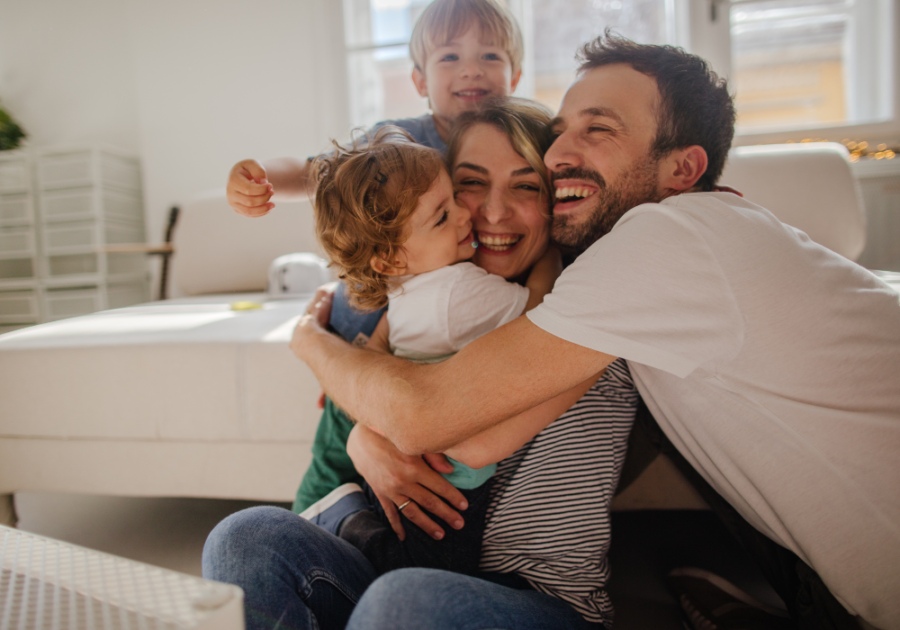 man hugging his wife and kids how many hugs we need each day