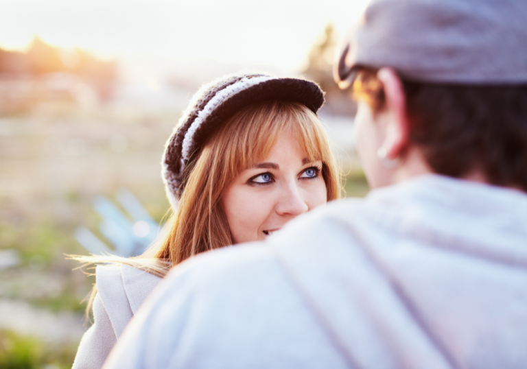 woman wearing a hat smiling gut feeling you're meant to be with someone