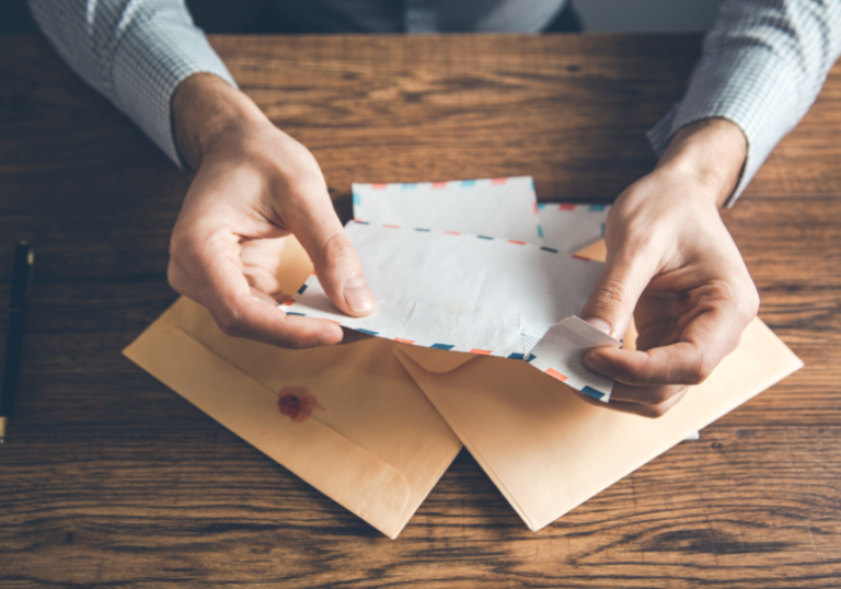 hands opening a letter open when letters for him