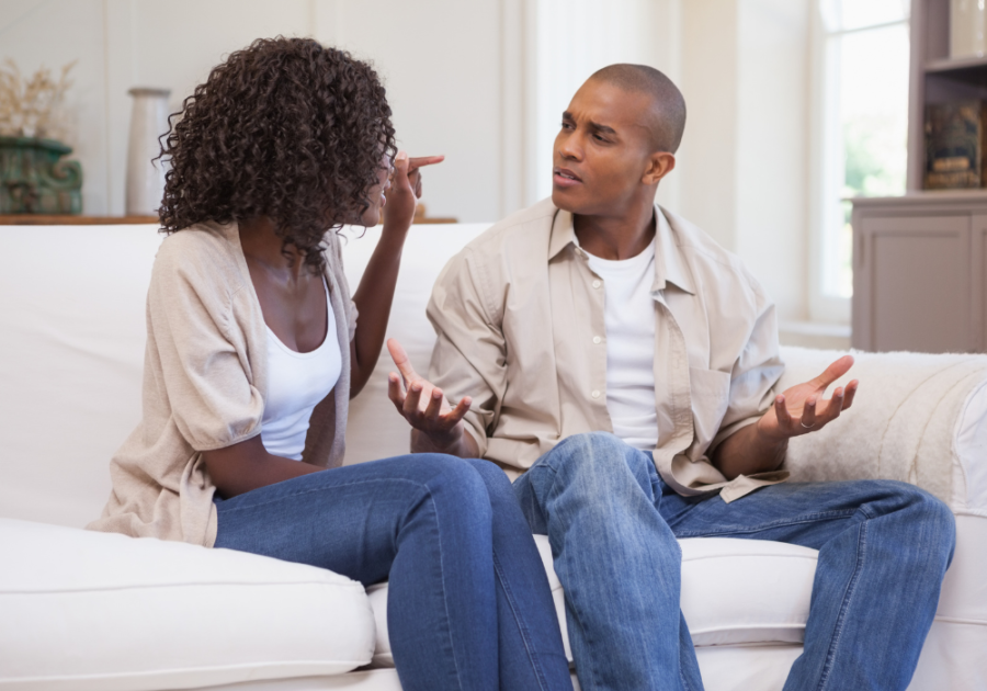 couple in matching clothes talking in couch feeling trapped in a relationship