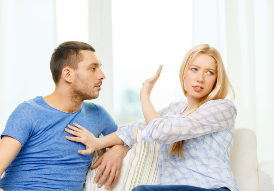 wife with hand raised to husband feeling trapped in a relationship