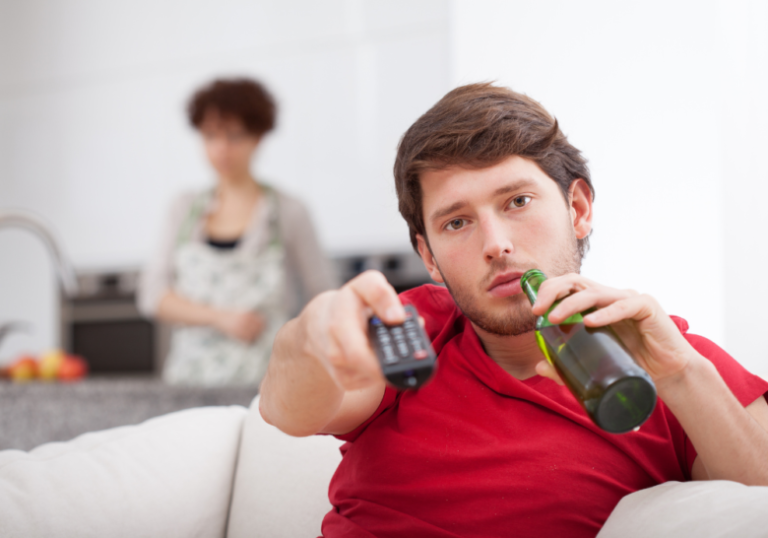 man drinking bottled drink while holding the remote deadly signs of an immature man