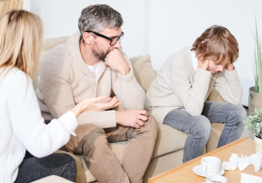 kid covering his ears while parents are talking dysfunctional family roles