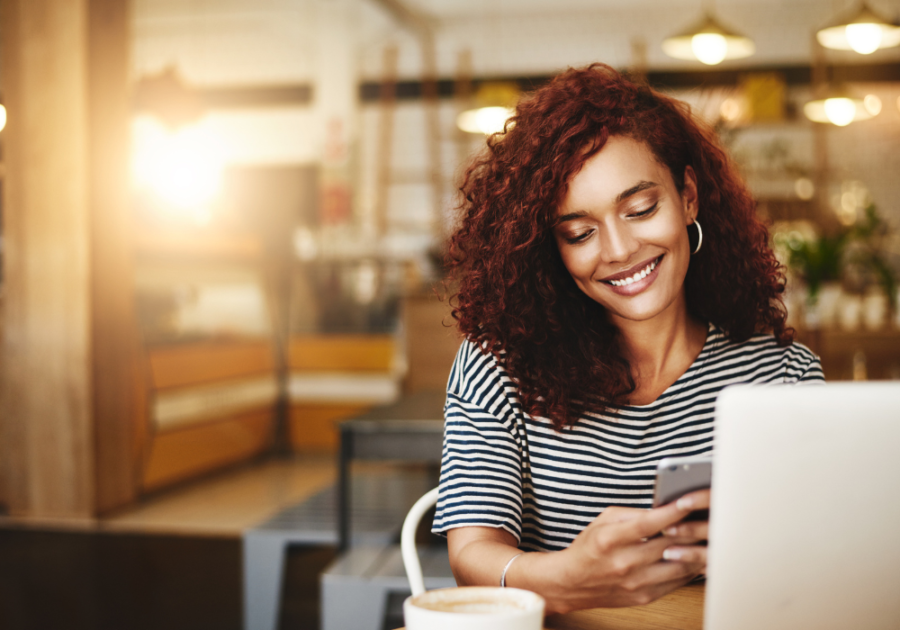 woman smiling while looking at her phone compliments for girlfriend