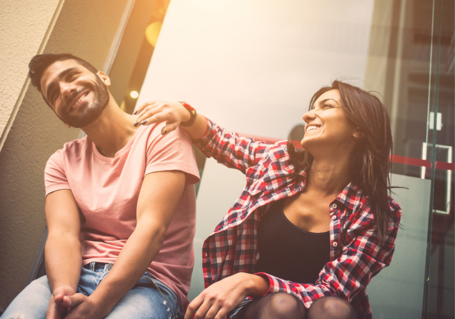 couple being playful at each other leading someone on