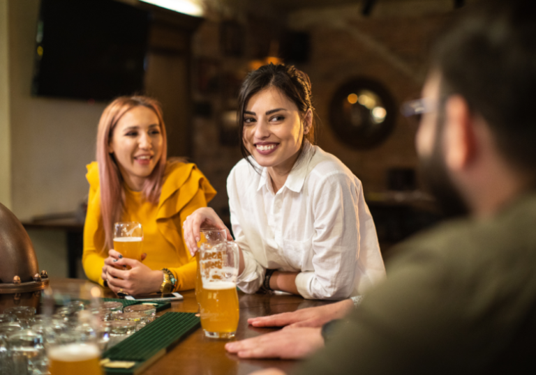 woman and friends having drinks in a long-term relationship but have feelings for someone else