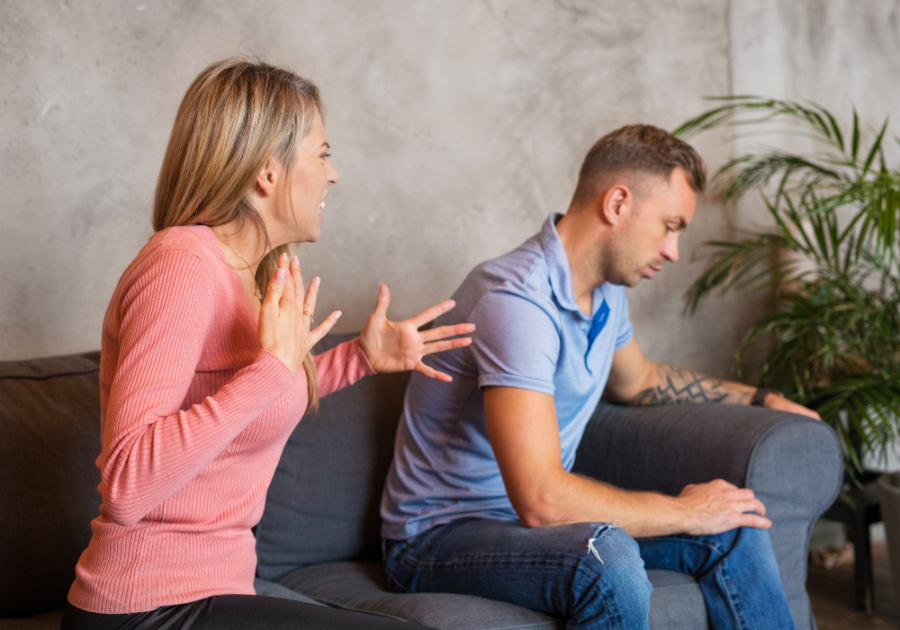 couple in the couch while woman is talking loud how to stop yelling in a relationship