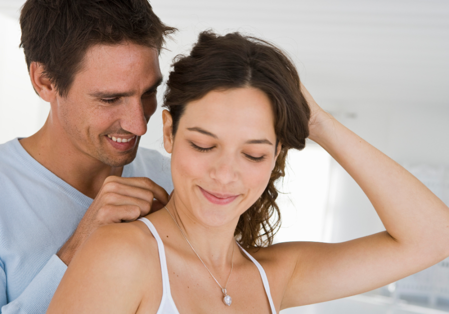 man helping woman wear a necklace narcissist love bombing