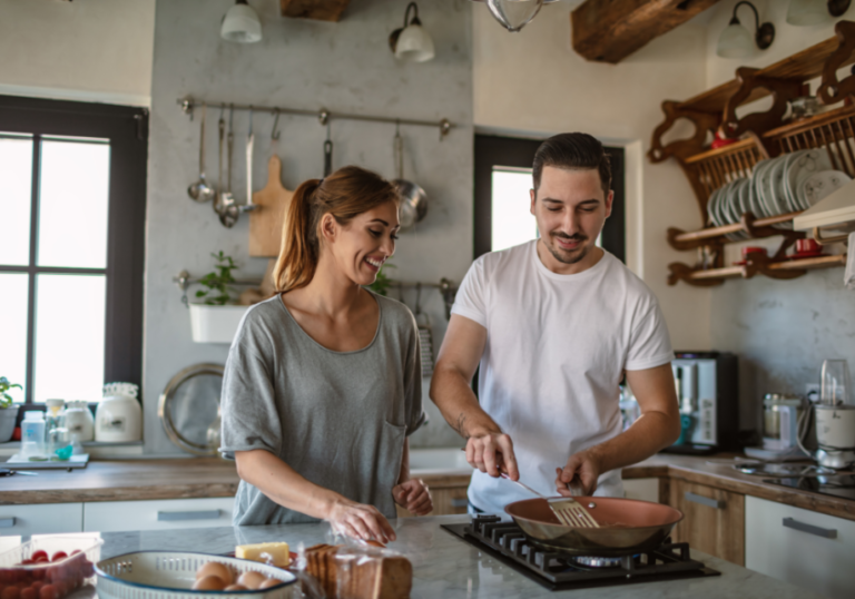 couple in kitchen cooking 50-50 relationship