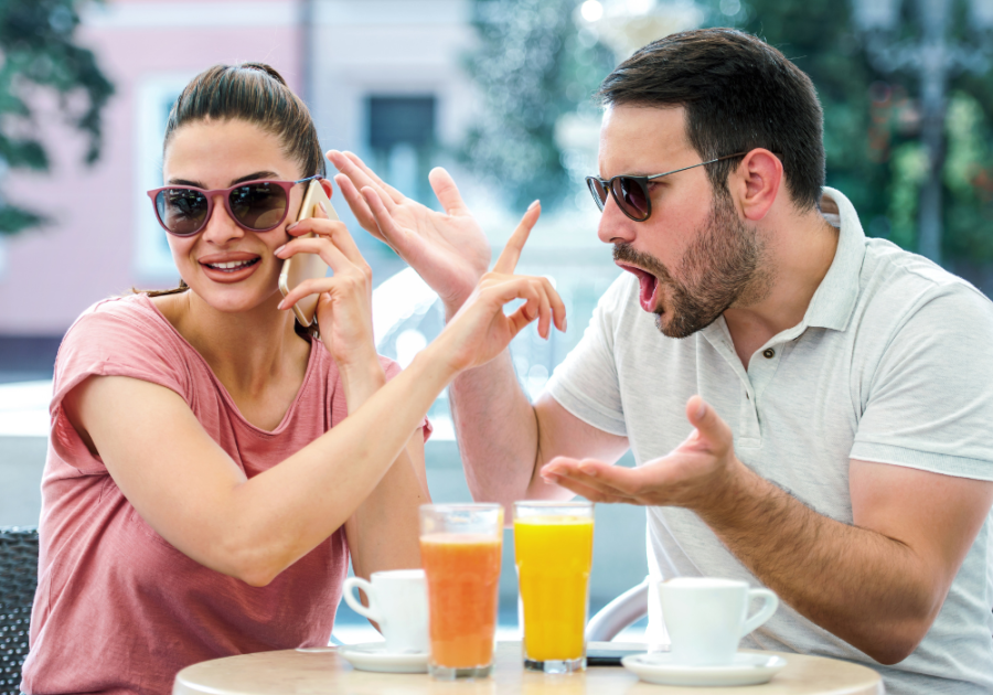 woman talking on phone trying to shush man red flags in a relationship with a woman