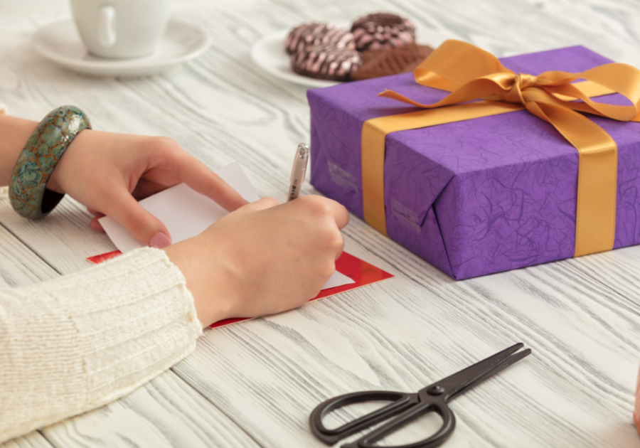 person writing a note for a gift emotional birthday wishes for boyfriend