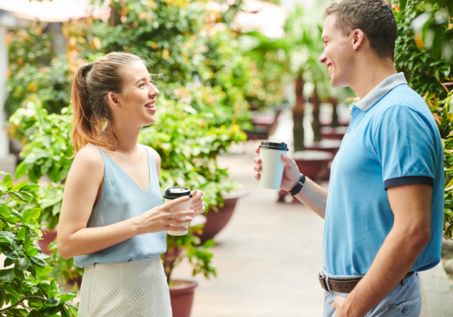 man and woman having coffee talking beta male traits