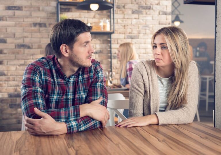 man and woman talking at table how to know it's time to break up