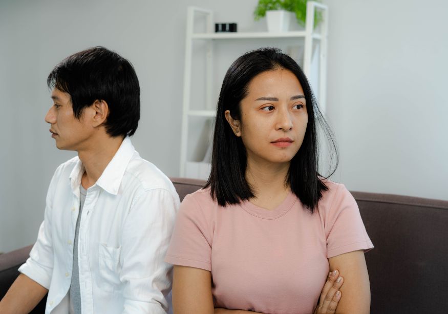 man and woman on sofa stone faced verbally abusive husband