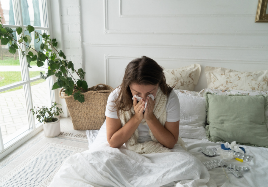 woman in bed blowing nose Good Excuses To Miss Work On Short Notice