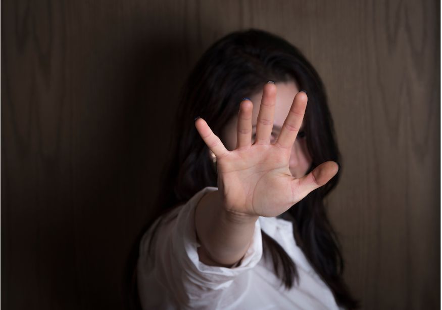 woman holding out hand to block why am I so antisocial