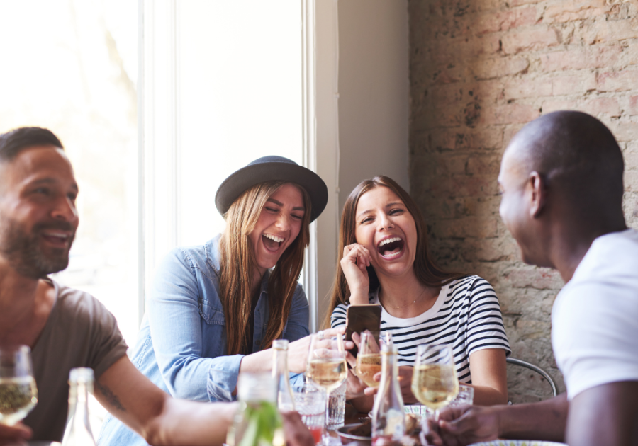 couples drinking wine laughing Paranoia Questions Game