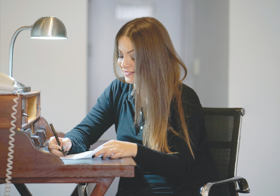 woman sitting at desk writing How to Write a Letter to Your Future Husband 