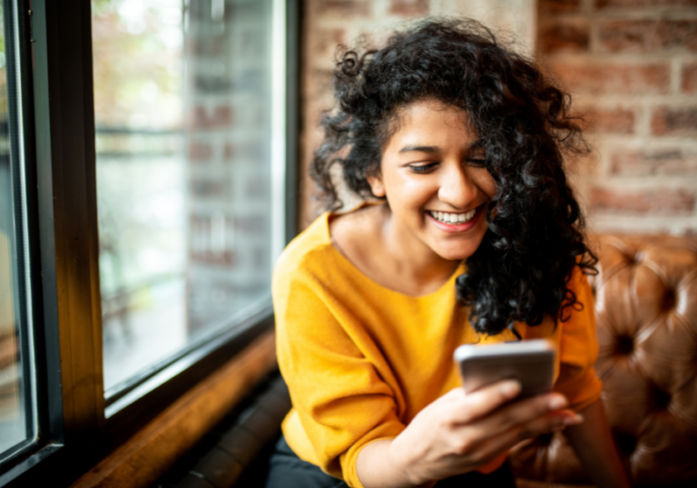 woman smiling on phone Funny Hinge Prompt Answers