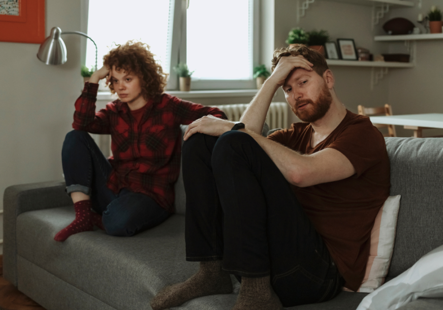 couple sitting together on sofa stages of a dying marriage