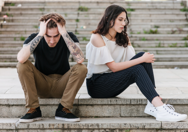 couple sitting on steps emotions Signs He's Pretending To Love You