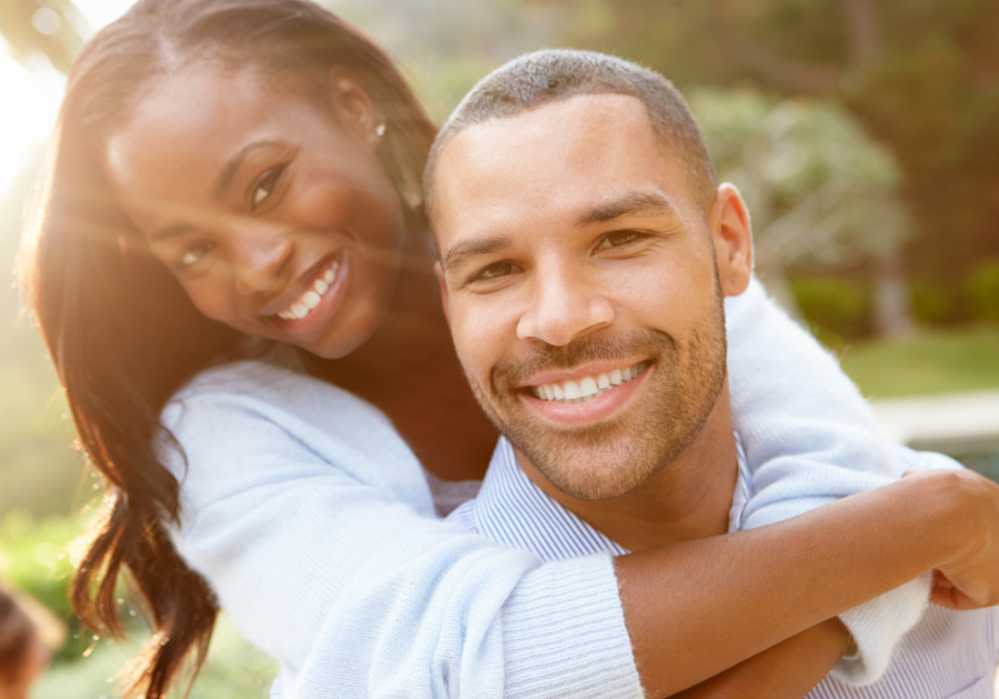 woman hugging man from behind hero instinct