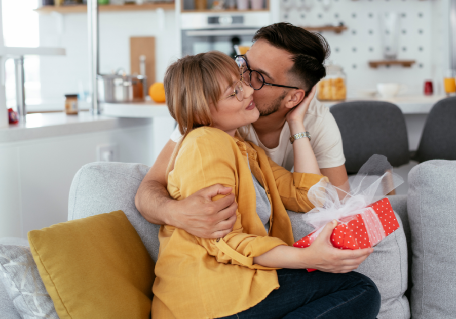 man kissing women with gift birthday letters for husband