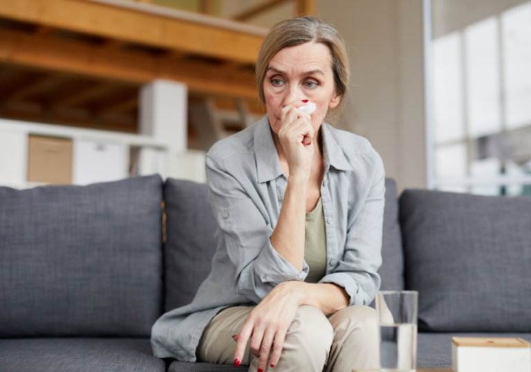 woman sitting on sofa sad How To Deal With Having an Estranged Daughter