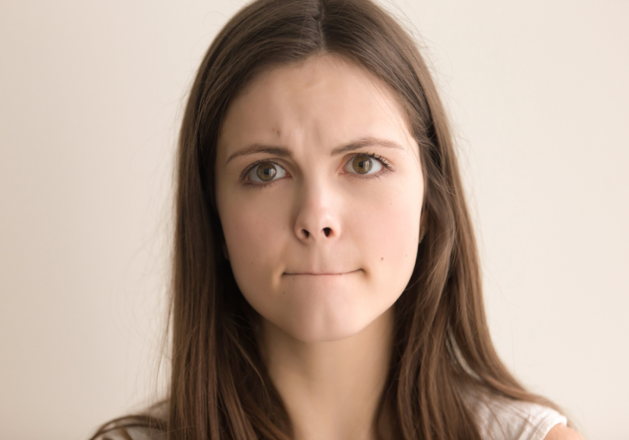 woman biting lips headshot why am I so indecisive