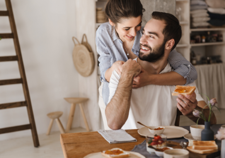 woman hugging man at dining table hero instinct