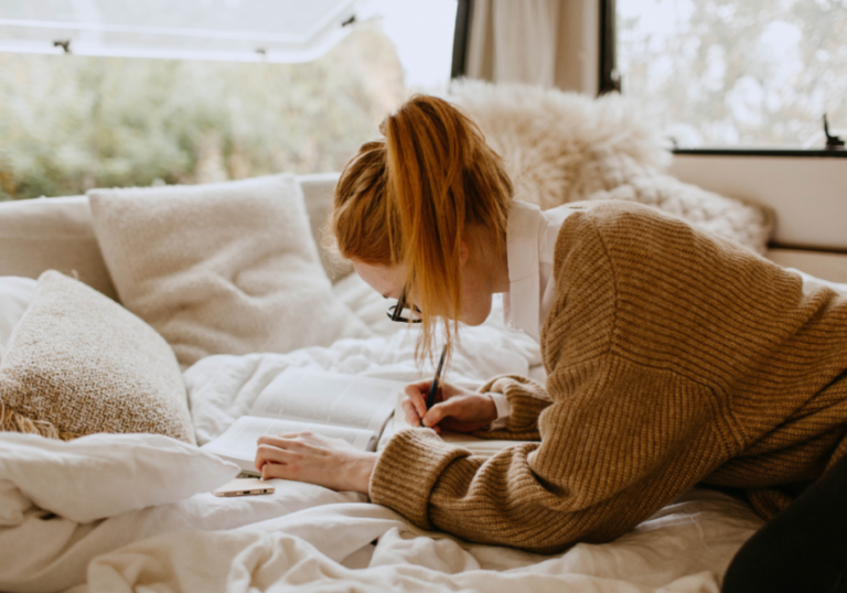 woman writing on paper birthday letters for husband