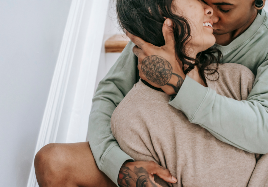 man embracing woman from behind Signs He Sees You As Special