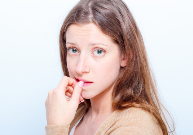 headshot of woman biting her nails how to deal with insecurities in a relationship