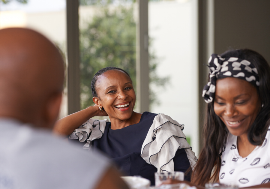 women laughing at table questions to ask your family