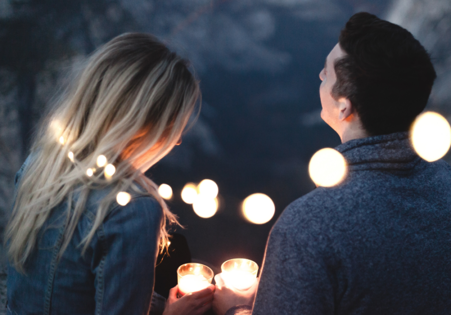 couple outside at night with candles Signs a Capricorn Man Is In Love with You