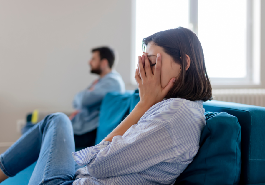 couple sitting on sofa woman covers face how to deal with insecurities in a relationship