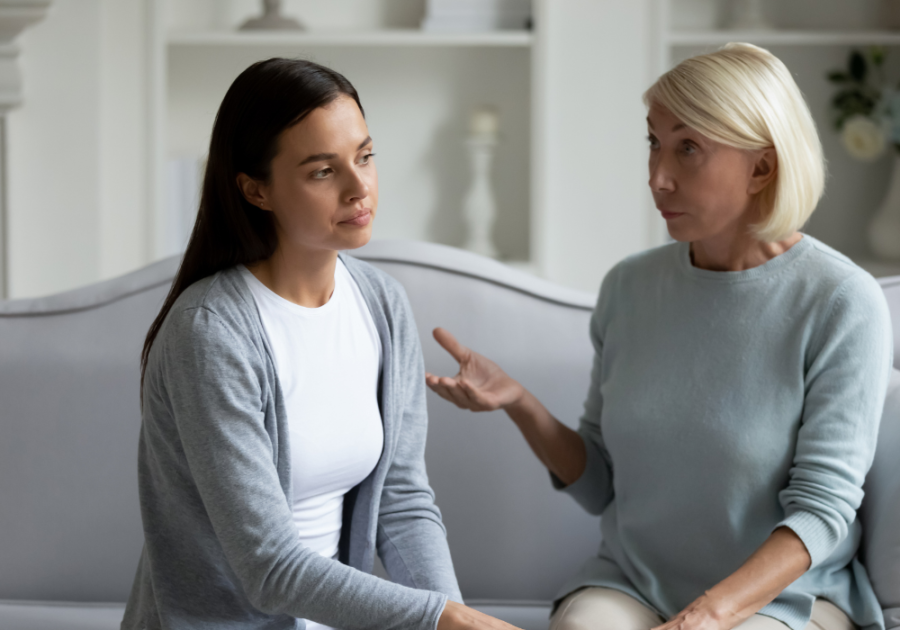 older woman and younger woman talking on sofa healthy ways to respond when your grown child hurts your feelings