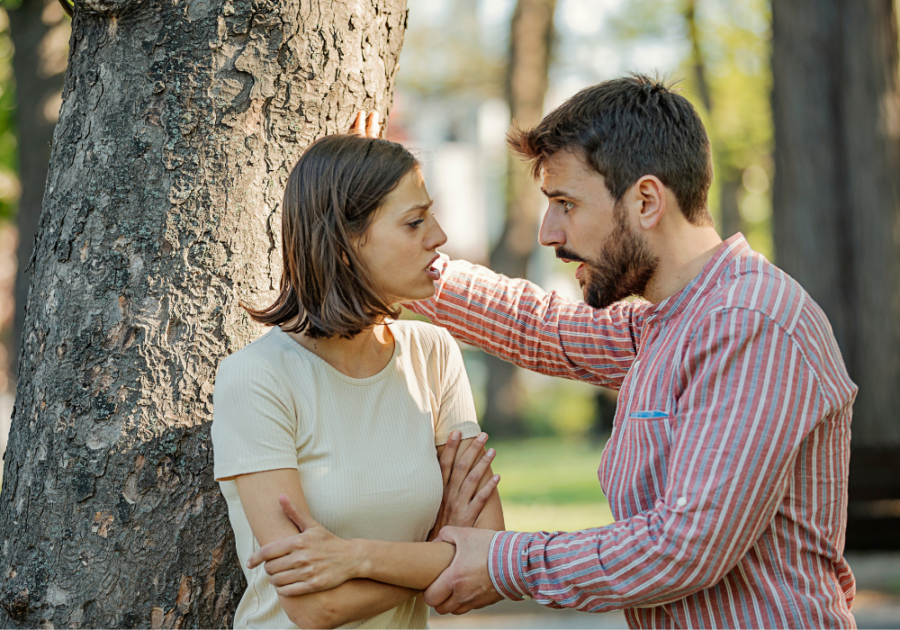 woman and man standing by tree arguing Expectations in a Relationship