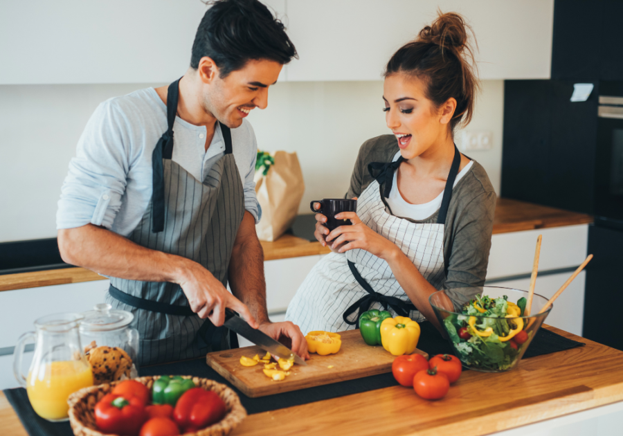 couple in kitchen cooking Signs a Capricorn Man Is In Love with You