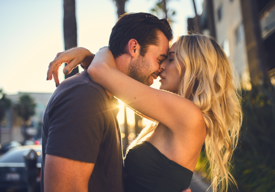 couple hugging closely man smiling What Makes A Man Want To Kiss A Woman