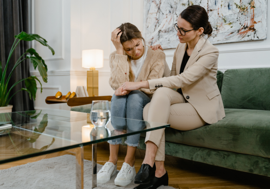 woman consoling other woman on couch How to Validate Someone's Feelings