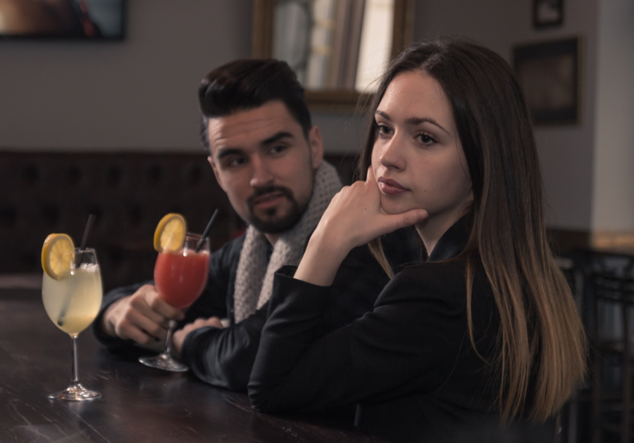 couple sitting at bar why a Guy Stares At You But Never Smiles