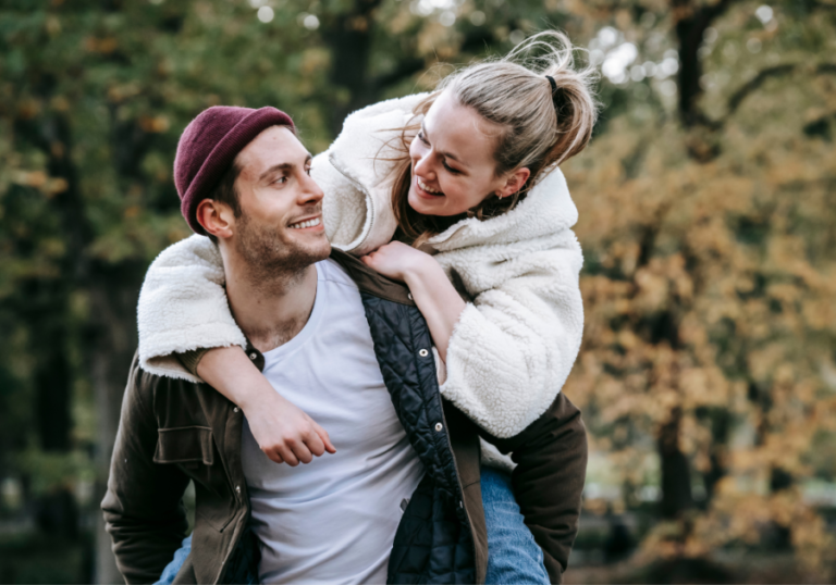 woman riding on man's back Ways a Cancer Man Tests You