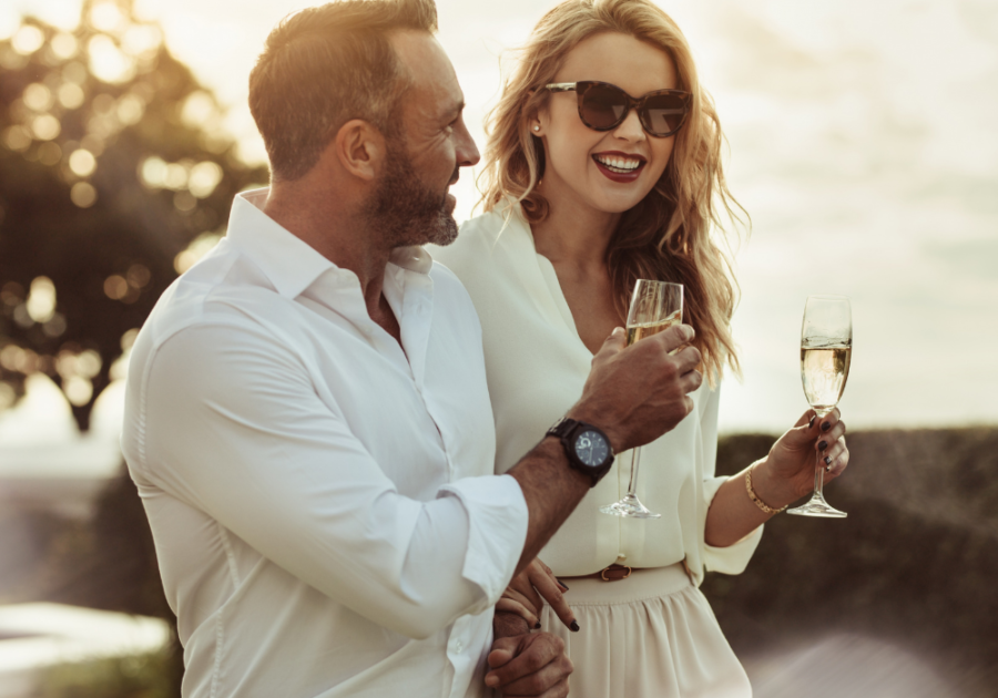 couple drinking wine outdoors high-value woman