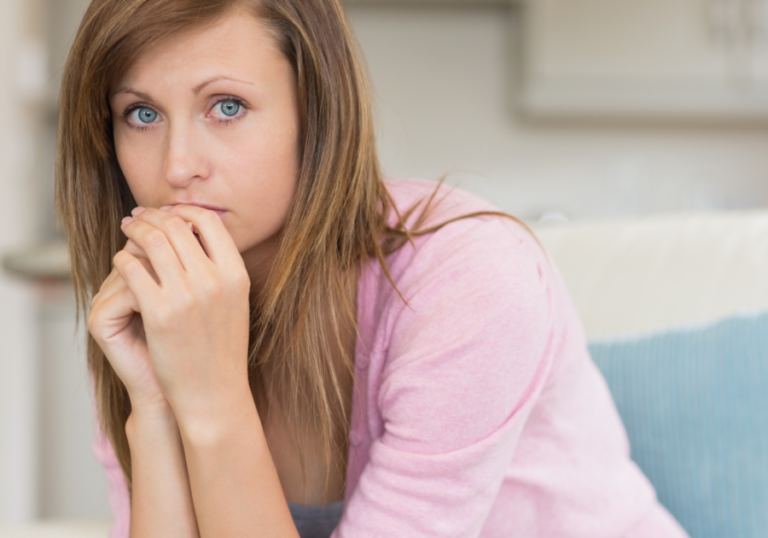 woman sitting alone nervous I cheated on my boyfriend