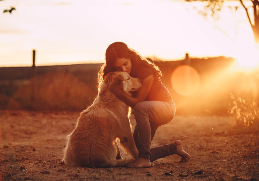 woman hugging dog high-value woman